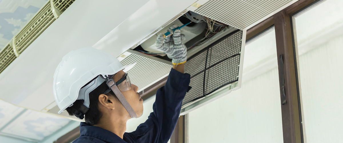 denver air conditioner cleaning man checks AC unit