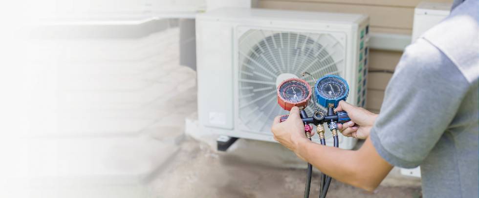 air conditioner technician checks operation of air conditioners