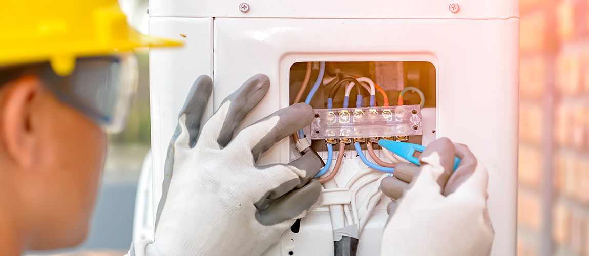 air conditioner technician is checking air compressor system 