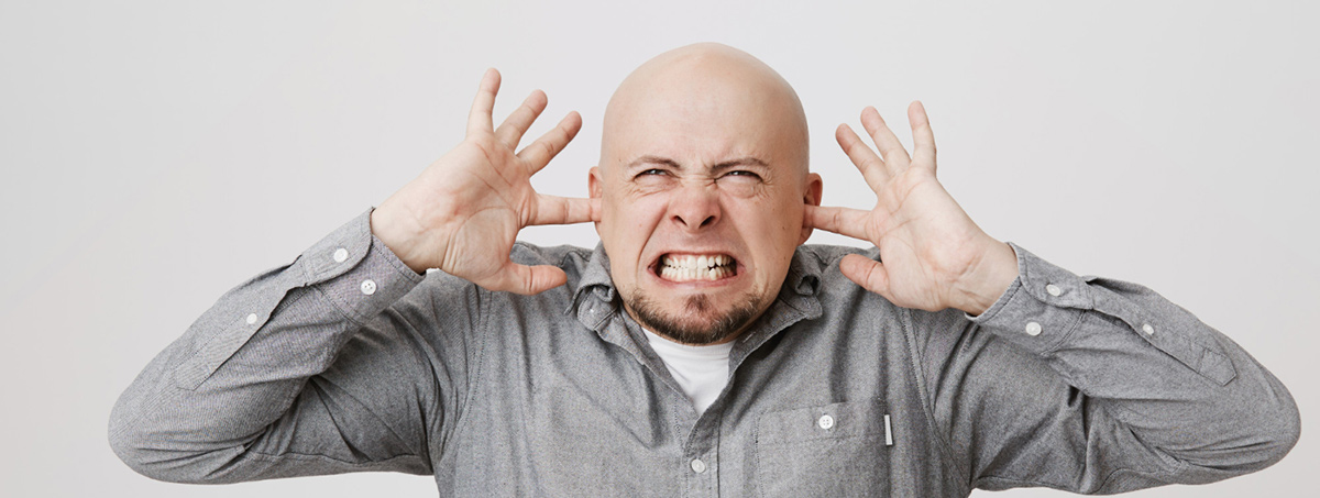 angry bothered bald guy shut ears with fingers