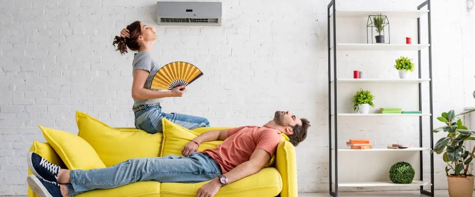 man and women on yellow couch ac unit not working