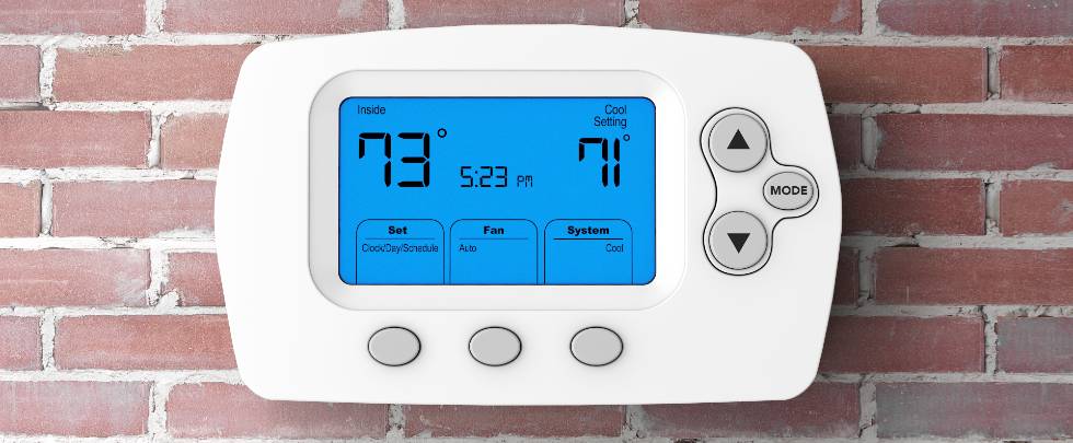 programming thermostat on brick wall