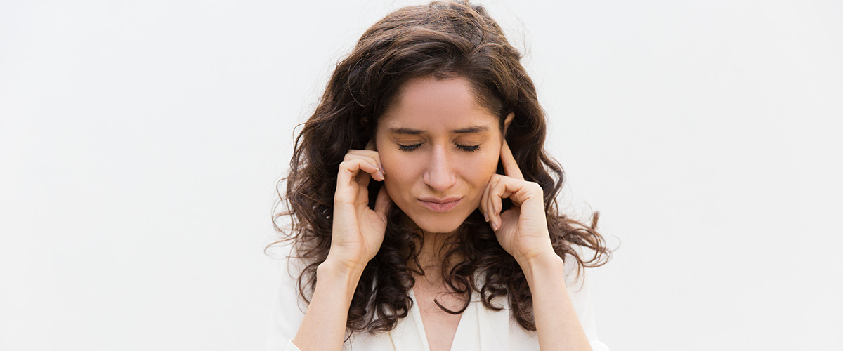 Stressed Woman Holding Ears