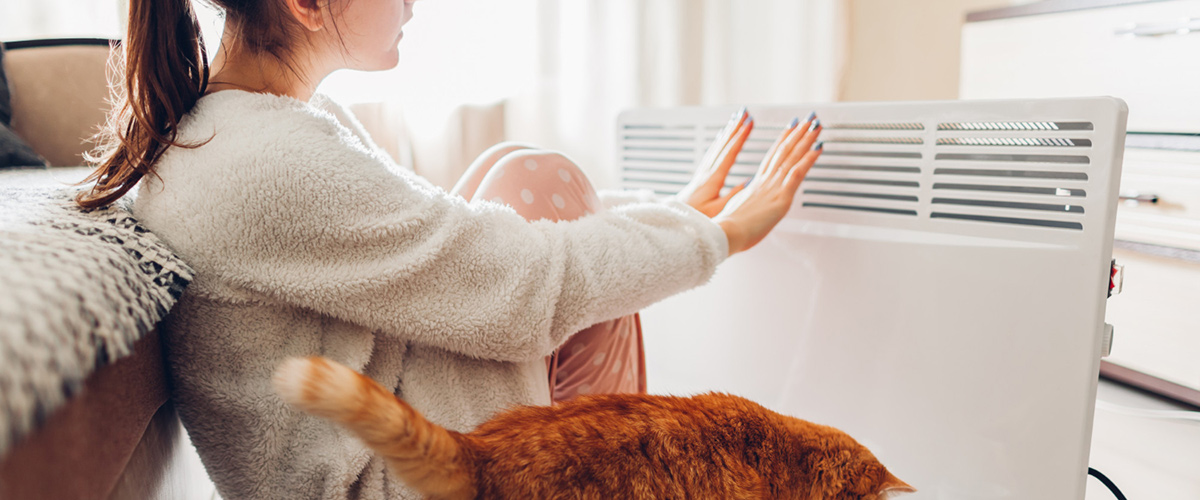 using heater home winter woman warming her hands