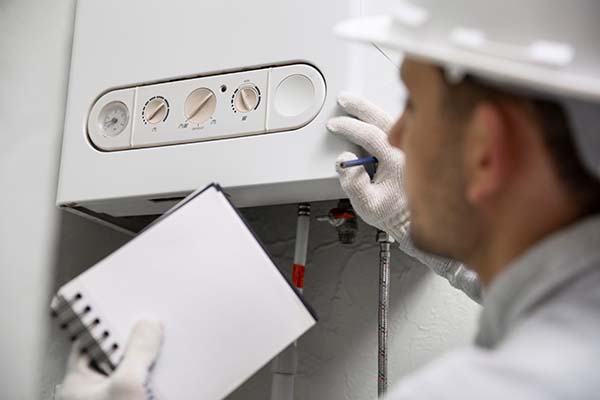 plumber repairing tankless water heater