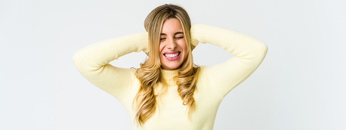 blonde woman covering ears with hands loud dishwasher noise