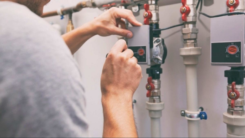 man installing new furnace in westminster co home