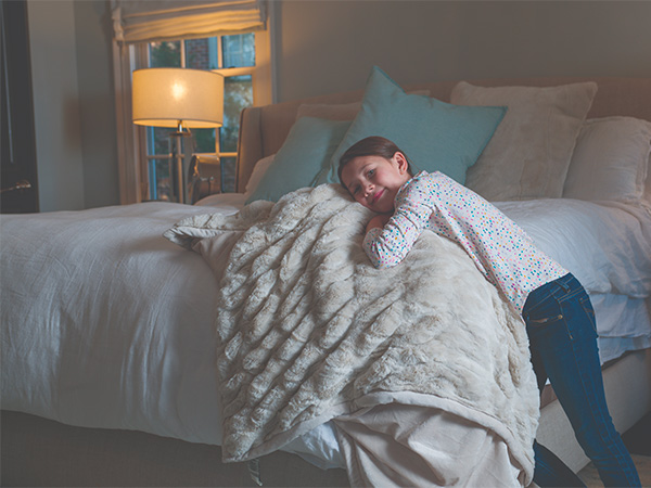 Young girl with a comforter