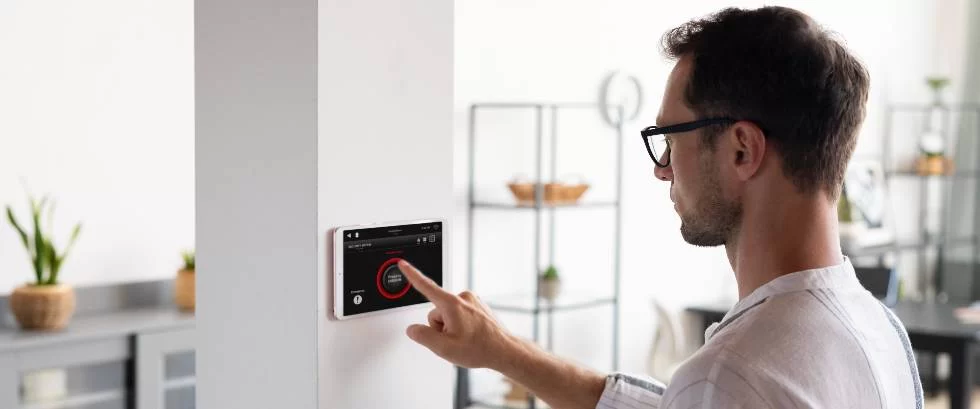 man adjusting ac thermostat