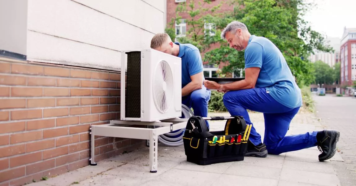 2 men on an AC install in Denver