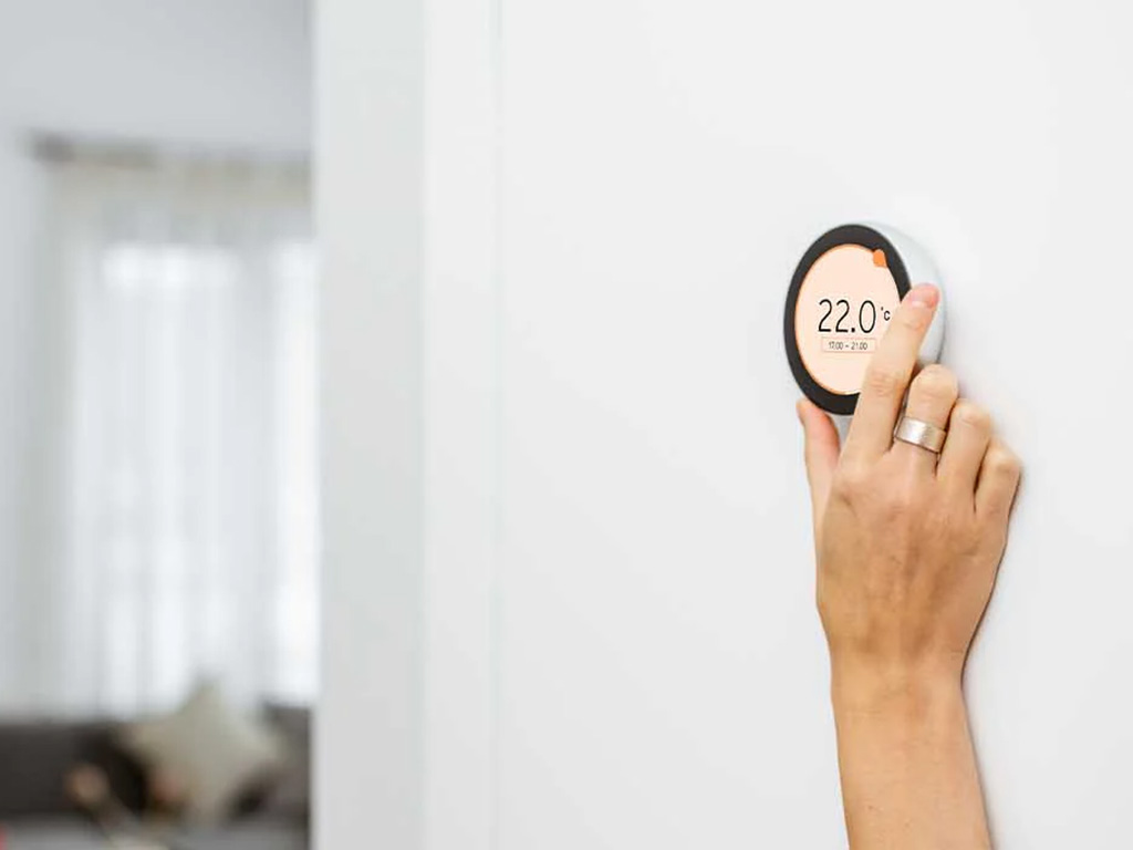 Furnace Will Not Blow Hot Air: Complete Troubleshooting Guide for Homeowners 2 Furnace Will Not Blow Hot Air: Complete Troubleshooting Guide for Homeowners woman's hand adjusting furnace thermostat