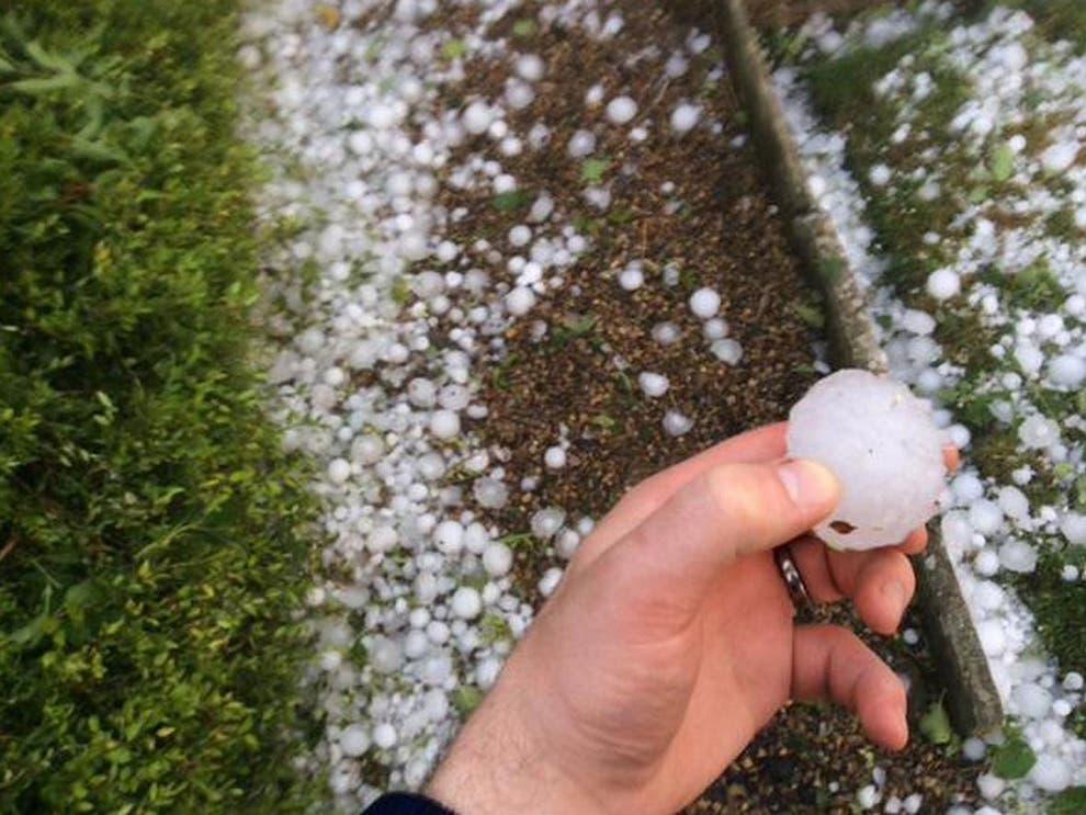 Large Hailstorm with hand holding hail