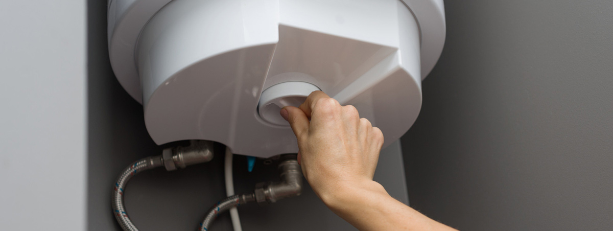 How Do Hot Water Heaters Work? 1 How Do Hot Water Heaters Work? hands setting temperature water heater electric